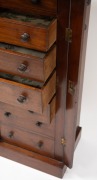 An antique English mahogany Wellington chest of seven graduated drawers with carved corbel decoration, bearing brass maker's plaque "W.H. TRAVERS, Endell St. & Castle St. Long Acre, W.C.", 19th century, 102cm high, 49cm wide, 36cm deep. - 3