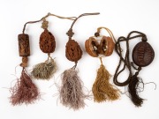 Five assorted Chinese carved nut ornaments and amulets, 20th century.