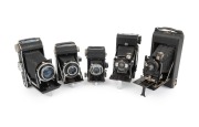 FOLDING CAMERAS: Early/mid-20th century group comprising Balda Beltica, Ernemann Bob (00), Franka Rolfix II, Kershaw Eight-20 Penguin, and Welta Weltax. (5 items)