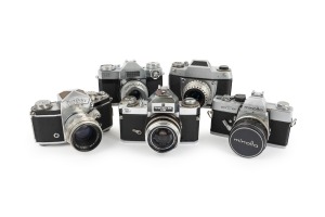 SLR CAMERAS: 1950s-60s group comprising Ihagee Exa IIb, Ihagee Exakta Varex IIa, Minolta SRT101, Zeiss Ikon Contaflex, and Zeiss Ikon Icarex 35 CS. (5 items)