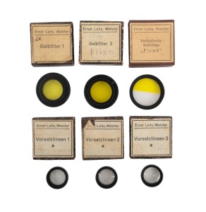 LEITZ: Group of lens filters, all in original maker's boxes; boxes labelled "Gelbfilter 1", "Gelbfilter 2", "Verlaufende Gelbfilter FIRAD", "Vorsatzlinsen 1", "Vorsatzlinsen 2", and "Vorsatzlinsen 3". (6 items)