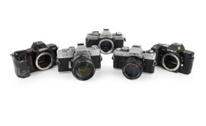 MINOLTA: Group of 1970s-80s SLRs, comprising Minolta 7000 (body only), Minolta Dynax 7000i (body only), Minolta SRT Super (MC Rokkor-PG 58mm f1.2), Minolta X-500 (MD Rokkor 50mm f1.7), and Minolta XG-1 (body only). (5 items)