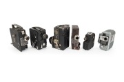 MOVIE CAMERAS: Group of early-20th century movie cameras, comprising Camera & Projector Midas, Campro Cine Camera Projector, Dekko Camera Dekko, Eumig Servomatic, Path&eacute; Webo A, and Univex Model A8. (6 items)