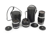 OLYMPUS: Group of lenses, all with front and rear caps present, comprising G. Zuiko Auto-W 25mm f2.8 (with case), E. Zuiko Auto-T 100mm f3.5 (with Olympus UV lens filter, and case) and OM-System G. Zuiko Auto-W 35mm f2.8. (3 items)