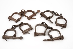 Group of four reproduction convict handcuffs with keys, late 20th century, the largest 30cm long.