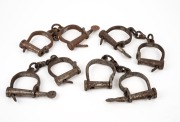 Group of four reproduction convict handcuffs with keys, late 20th century, the largest 30cm long.