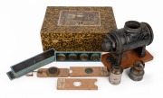 ERNST PLANK: Circa 1900s toy magic lantern in well-preserved maker's box, with twelve slides and various accessories; box dimensions 10 x 28 x 19cm when closed.
