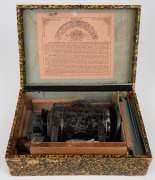 ERNST PLANK: Circa 1900s toy magic lantern in well-preserved maker's box, with twelve slides and various accessories; box dimensions 10 x 28 x 19cm when closed. - 2