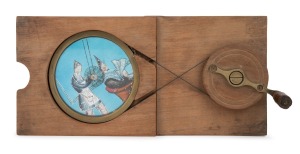 Amusing wooden slide for magic lantern depicting an over-enthusiastic barber, combination double-pulley/slipping slide-type, mid-19th century; 11 x 24cm overall.