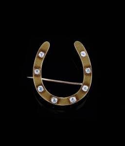 HORSESHOE BROOCH: Of plain polished design set with eight old cut diamonds. The reverse inscribed "Presented to Louise Cooper by Uncle Harry from Australia August 21st 1889". 18ct yellow gold. Weight 7.3 grams