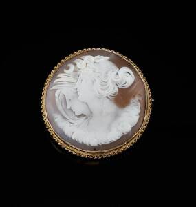 CAMEO BROOCH BY CARIS BROS, PERTH: The circular helmet shell cameo depicting Night and Day. Yellow gold.