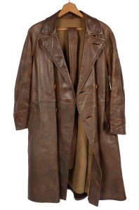 A vintage brown leather motorcycle touring trench coat; together with two pairs of brown leather gloves, circa 1930.