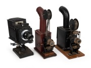 Group of projectors comprising two earlier film-strip lanterns and an Ensign No. 6 Optiscope. (3 items)