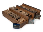 BIBLICAL IMAGERY: A large collection of early-20th century 83 x 83mm glass slides for magic lantern, housed in three timber cases. (280+ items)