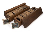 BIBLICAL IMAGERY: A large collection of early-20th century 83 x 83mm glass slides for magic lantern, housed in two timber cases. (190+ items)