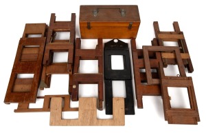 Group of sixteen slide holders for magic lantern (mostly wooden, including three "Eclipse Self-Centering" types by R.R. Beard), plus timber case for glass slides.