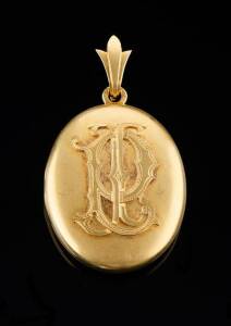 LOCKET BY STEINER, ADELAIDE c.1880: Of oval form with bloomed finish and applied initials. Stamped H Steiner Adelaide. Yellow gold. Weight 36.6 grams.   