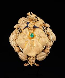 GOLD LOCKET BROOCH possibly by LAMBORN AND WAGNER, MELBOURNE c.1870: Of oval form and vine and grape motif, the front leaf panel opening to reveal a handpainted miniature of a bearded gentleman. Yellow gold. Weight 32.44 grams. Length 6.5cms.&nbsp;