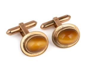 A pair of vintage 18ct gold and cabochon tiger eye cufflinks, mid 20th century, stamped "18K", ​​​​​​​9 grams total.