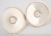 GEORG JENSEN pair of Danish sterling silver candle holders, designed by Harald Nielsen (1892-1977), mid 20th century, ​​​​​​​3cm high, 6.5cm diameter, 76 grams total. - 2