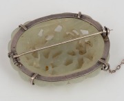 An antique Chinese carved jade brooch with silver mount, 19th/20th century, ​​​​​​​5.5cm wide. - 2