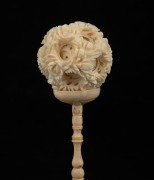 A Chinese carved ivory puzzle ball on figural stand, early to mid 20th century, 22cm high overall. - 2