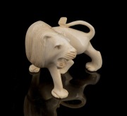 An Indian carved ivory lion ornament, early to mid 20th century, ​​​​​​​9cm high, 11cm wide.