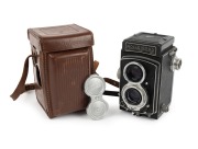 ROLLEI: Rolleicord IV TLR [#1390068], c. 1953, Schneider-Kreuznach Xenar 75mm f3.5 lens [#3875154], Synchro-Compur shutter, Rollei double lens cap, Rollei leather case.