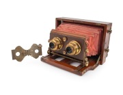LANCASTER: "Stereo Instantograph" folding stereo camera, c. 1891, plate dimensions 8.5 x 17cm, twin Lancaster brass lenses with iris diaphragms, extremely scarce clip-on brass stereo shutter, red bellows.