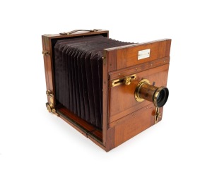 Late-19th century tailboard camera, plate dimensions 21.5 x 18cm, J.H. Dallmeyer 8&frac12; x 6&frac12; Rapid Rectilinear brass lens [#42288] with Waterhouse stop, "Baker & Rouse - Melbourne, Sydney, Adelaide, Brisbane" retailer's inlay.