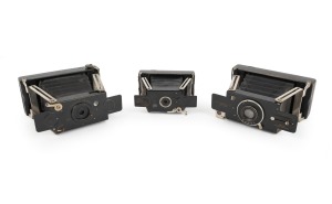HOUGHTON: Group of c. 1910s strut-folding cameras, comprising Ensignette No. 1, Ensignette No.2, and Ensignette No. 2B De Luxe. (3 items)