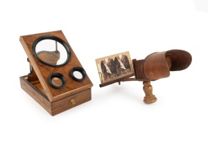Folding stereo-graphoscope with stereo card, late-19th century, maximum height 32cm, together with handheld stereoscope of similar vintage, also with stereo card. (2 items)