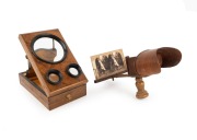 Folding stereo-graphoscope with stereo card, late-19th century, maximum height 32cm, together with handheld stereoscope of similar vintage, also with stereo card. (2 items)