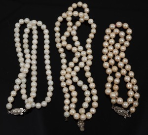 Three vintage pearl necklaces, all with silver clasps (one clasp detached from strand), 20th century. the largest 60cm long