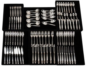 GEORG JENSEN "Acorn pattern" Danish silver cutlery setting for eight, comprising of butter knives, oyster forks (one missing), parfait knives (two missing), soup spoons, fish knives, fish forks, entree knives, entree forks, dinner forks, dinner knives, dinner spoons, dessert spoons, teaspoons, (101 items), 3,386 grams total silver weight (excluding steel blade knives); Together with a vintage teak canteen of four drawers, 30cm high, 60cm wide, 36cm deep.