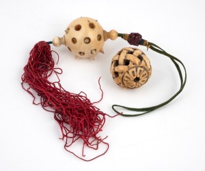 An antique Chinese carved puzzle pendant on silk cord with tassel, together with an antique Japanese carved ivory Ojime bead, 19th/20th century, (2 items), the largest 25cm high including silk.