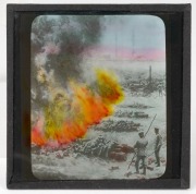 A collection of 83 x 83mm photographic glass slides for magic lantern, many hand-tinted, including many World War I views (British Whippet tank charge, burning of piles of German war dead, King George V touring ordnance factory). (100+ items) - 2