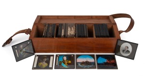 A collection of 83 x 83mm glass slides for magic lantern, in 10 x 38 x 11cm timber case; subjects include the laying of the first transatlantic telegraph cable, British royalty, and others. (70+ individual slides)