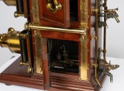 BIUNIAL MAGIC LANTERN: Large c. 1880s mahogany and brass example with impressive quadruple-extension lens barrels, tin chimney element, limelight burner apparatus, four side-opening doors with red or blue peepholes, together with two condenser lenses and - 7