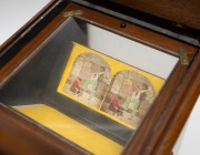 Late-19th century tabletop stereoscope, hand-operated slide magazine loaded with 50 stereo cards (abolition of slavery, paddlesteamer, railways, risqu&eacute; types), "Abraham & Co. Opticians Liverpool" retailer's plate; dimensions 52 x 27 x 29cm. - 4