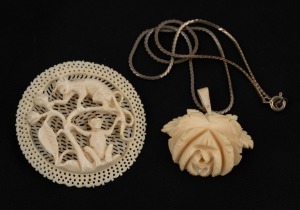 A carved ivory floral pendant on a white metal chain; together with a carved ivory monkey brooch, 19th/20th century, (2 items), the brooch 5cm diameter.
