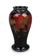 MOORCROFT "Pomegranate" English pottery vase on blue ground, impressed "Moorcroft, Made In England" with green signature mark, 18.5cm high.