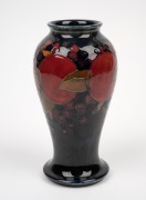 MOORCROFT "Pomegranate" English pottery vase on blue ground, impressed "Moorcroft, Made In England" with green signature mark, 18.5cm high. - 2