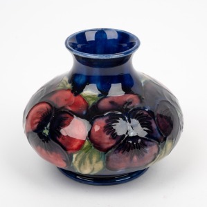 MOORCROFT "Pansy" English pottery miniature vase on blue ground, impressed "Moorcroft, Made In England", 7cm high.