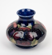 MOORCROFT "Pansy" English pottery miniature vase on blue ground, impressed "Moorcroft, Made In England", 7cm high. - 2