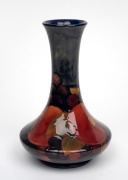 MOORCROFT "Pomegranate" English pottery vase on blue ground, impressed "Moorcroft, Made In England" with blue signature mark, 20cm high.