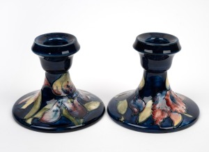 MOORCROFT "Orchid" pair of English pottery candleholders, impressed "Moorcroft, Made In England" with original paper labels, 8cm high each.