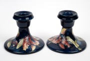 MOORCROFT "Orchid" pair of English pottery candleholders, impressed "Moorcroft, Made In England" with original paper labels, 8cm high each. - 2