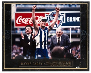 Six framed images, including 1996 Grand Final photograph signed by winning captain Wayne Carey of North Melbourne (33 x 26.5cm overall), photograph of Ross Oakley and Tim Watson in period garb outside the MCG for the AFL Centenary Re-Enactment match (52 x 45cm overall), photograph depicting Oakley at the launch of the 1991 Foster's Cup at St Kilda Marina with Greg Durham, Tony Peek, Alan Schwab and several others (48 x 33cm overall), and three others. (6 items)