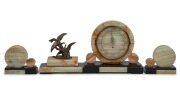 A French Art Deco three piece clock garniture set, green onyx and black slate with cast metal figural bird group, circa 1930, the clock 24cm high, 47cm wide.